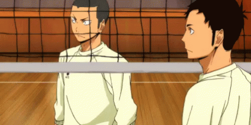 Two Volleyball Players Are Standing Next To Each Other On A Court . GIF