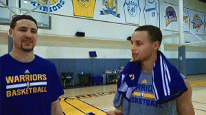 Two Warriors Basketball Players Are Talking On A Court GIF