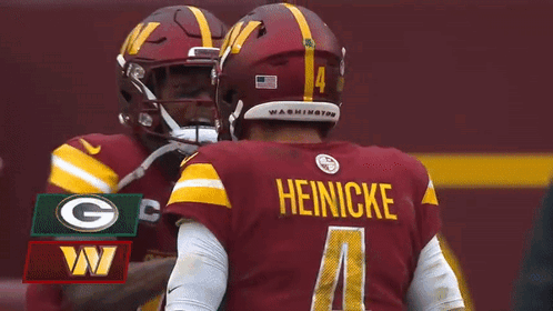 Two Washington Redskins Players Are Hugging Each Other During A Fox Nfl Game GIF