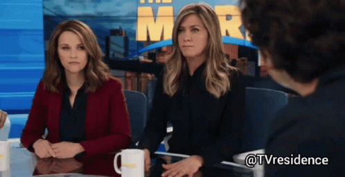 Two Women And Man At Table With Mr. Sign GIF