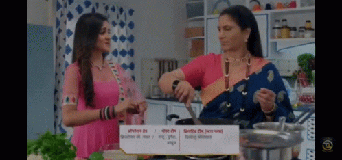 Two Women Are Cooking In A Kitchen With A Sign That Says ' Cooking ' GIF