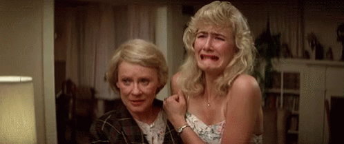 Two Women Are Crying In A Living Room . GIF