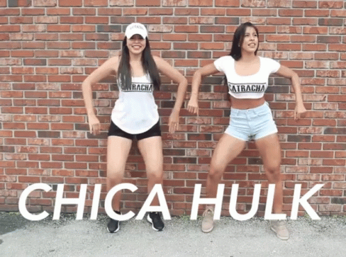 Two Women Are Dancing In Front Of A Brick Wall And The Words Chica Hulk Are Visible GIF