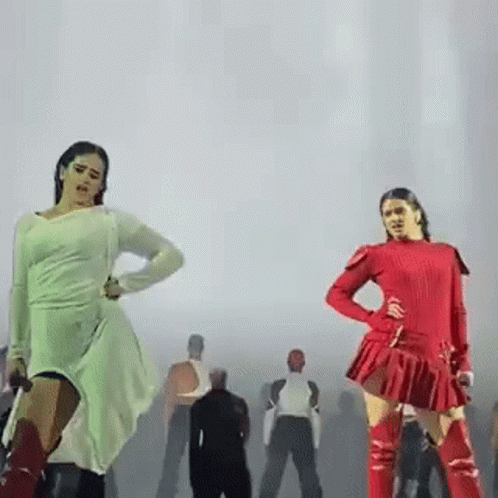 Two Women Are Dancing On A Stage In Front Of A Group Of People . GIF