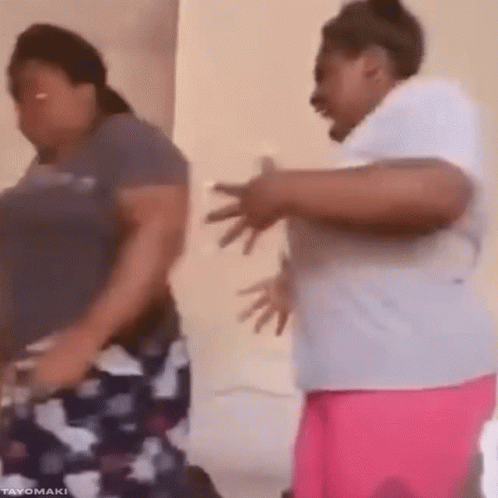 Two Women Are Dancing Together In A Room And One Of Them Is Laughing . GIF