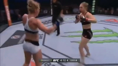 Two Women Are Fighting In A Boxing Ring With A Monster Energy Logo In The Background . GIF
