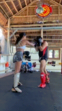Two Women Are Fighting In A Boxing Ring With A Sign Above Them That Says ' Fighting Club ' GIF