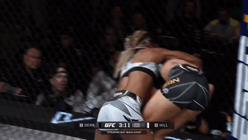 Two Women Are Fighting In A Boxing Ring With The Ufc 3:11 In The Corner GIF