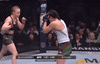 Two Women Are Fighting In A Boxing Ring With The Ufc Logo In The Background GIF