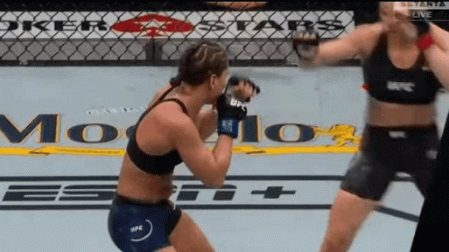Two Women Are Fighting In A Ring With A Sign That Says Joker Stars GIF
