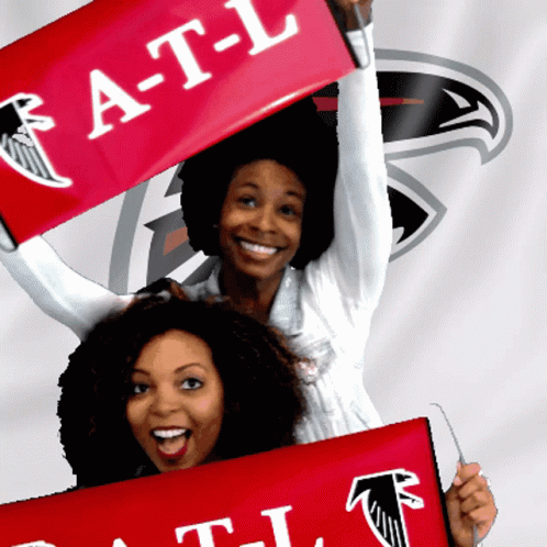 Two Women Are Holding Up A Red Banner That Says A-T-L GIF