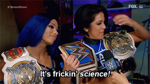 Two Women Are Holding Wrestling Championship Belts And Saying It 'S Frickin ' Science . GIF