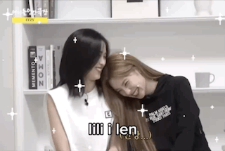 Two Women Are Hugging Each Other In Front Of A Bookshelf And Smiling . GIF