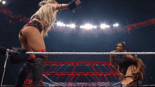 Two Women Are In A Wrestling Ring With The Word Raw On The Bottom GIF