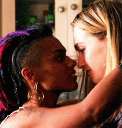 Two Women Are Kissing Each Other In A Kitchen . GIF