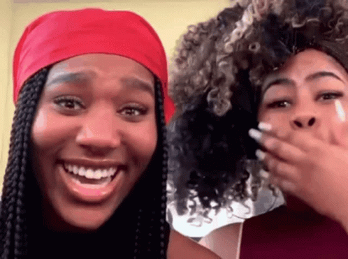 Two Women Are Laughing And One Has A Red Headband On GIF
