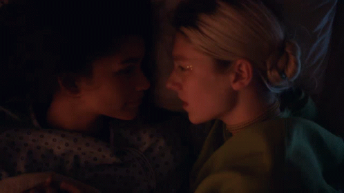 Two Women Are Laying Next To Each Other And One Has A Star On Her Face GIF
