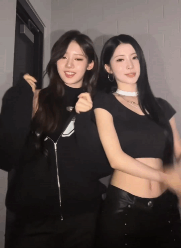 Two Women Are Posing For A Picture And One Has A Choker On GIF