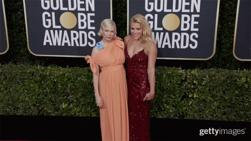 Two Women Are Posing For A Picture On The Red Carpet For The Golden Globe Awards GIF
