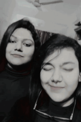 Two Women Are Posing For A Picture Together With Their Eyes Closed GIF