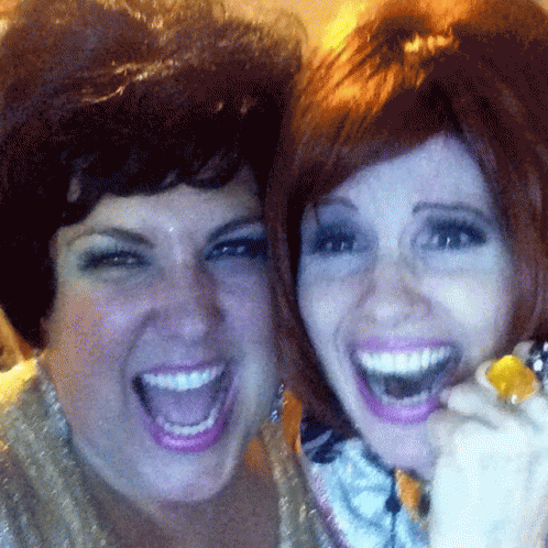 Two Women Are Posing For A Picture With Their Mouths Wide Open GIF