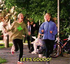 Two Women Are Running Down A Path And One Of Them Is Saying Let 'S Goooo ! GIF