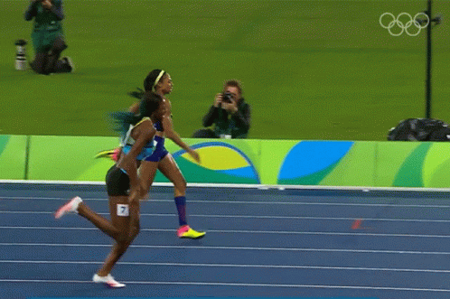 Two Women Are Running On A Track That Says Rio 2014 GIF