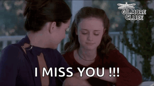 Two Women Are Sitting At A Table And One Of Them Is Saying I Miss You . GIF