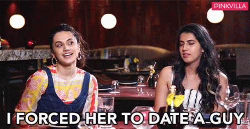 Two Women Are Sitting At A Table In A Restaurant And One Of Them Is Saying " I Forced Her To Date A Guy " GIF