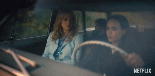 Two Women Are Sitting In A Car With Netflix Written On The Bottom GIF