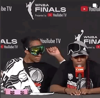 Two Women Are Sitting In Front Of A Youtube Tv Banner GIF