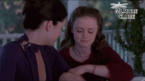 Two Women Are Sitting Next To Each Other And The Words Gilmore Clube Are On The Bottom GIF