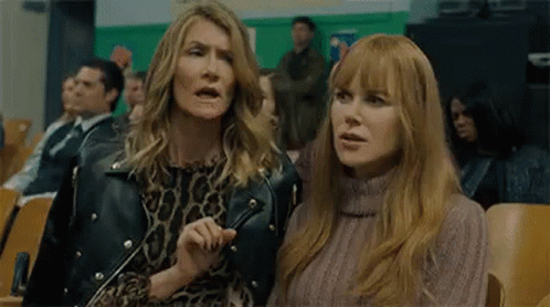 Two Women Are Sitting Next To Each Other In A Stadium . GIF