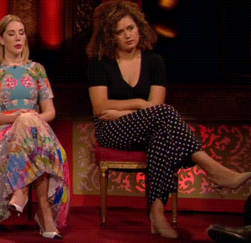 Two Women Are Sitting Next To Each Other With Their Legs Crossed And One Is Wearing Polka Dot Pants GIF