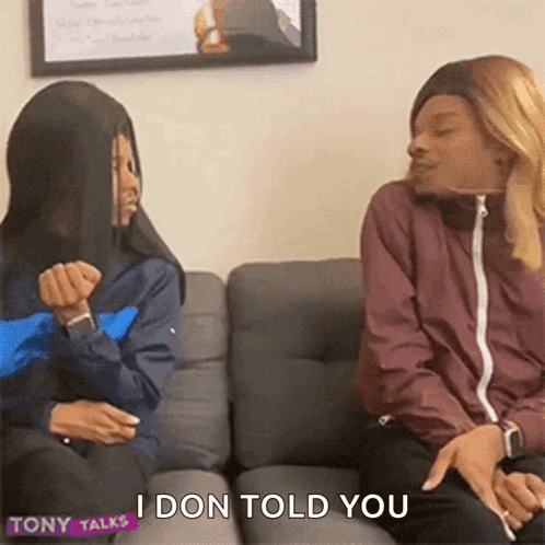 Two Women Are Sitting On A Couch Talking To Each Other And One Of Them Is Saying `` I Don T Tell You '' . GIF
