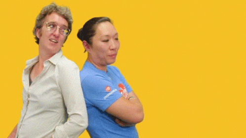 Two Women Are Standing Back To Back With The Words " You Got My Back " Behind Them GIF