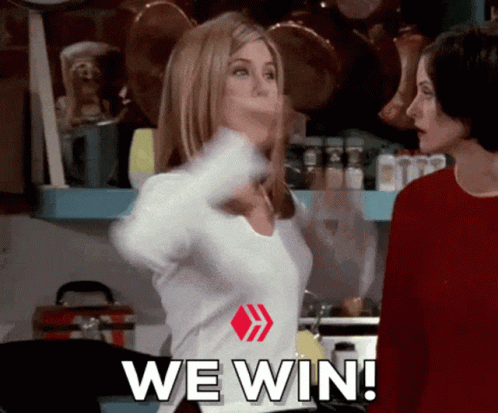 Two Women Are Standing In A Kitchen With The Words We Win Written On Their Shirts GIF