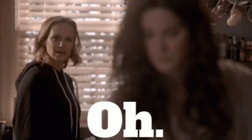 Two Women Standing In Front Of Window Saying Oh GIF