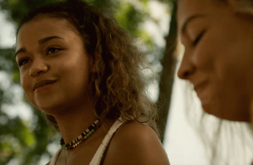 Two Women Are Standing Next To Each Other And One Has A Necklace On GIF