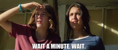 Two Women Are Standing Next To Each Other And One Of Them Is Holding Her Head . GIF