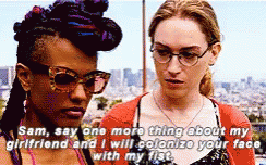 Two Women Are Standing Next To Each Other And One Of Them Is Saying " Sam Say One More Thing About My Girlfriend " GIF