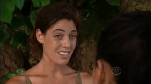 Two Women Are Standing Next To Each Other And Smiling At Each Other In Front Of A Tree . GIF