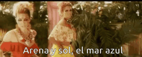 Two Women Are Standing Next To Each Other And The Words Arena Y Sol El Mar Azul Are Visible GIF
