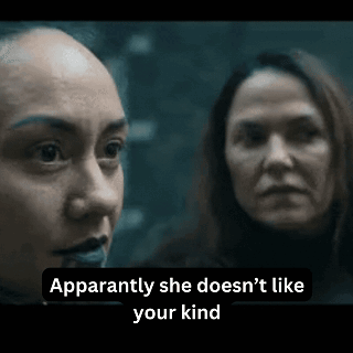 Two Women Are Standing Next To Each Other In A Dark Room . GIF