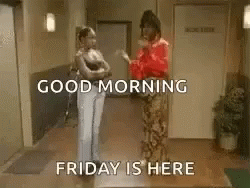 Two Women Are Standing Next To Each Other In A Hallway And Talking . GIF
