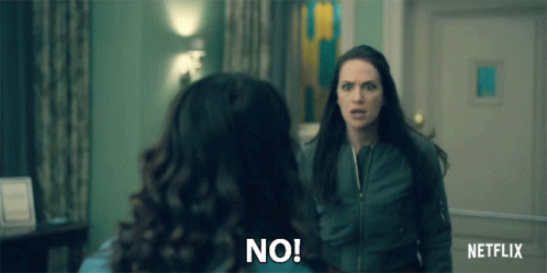 Two Women Are Standing Next To Each Other In A Room And One Is Saying No . GIF