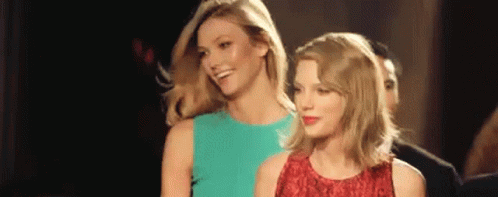 Two Women Are Standing Next To Each Other In A Room And Smiling . GIF