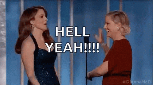 Two Women Are Standing Next To Each Other In Front Of A Microphone And Talking . GIF