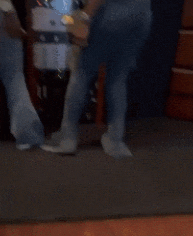 Two Women Are Standing Next To Each Other In Front Of A Rack Of Electronic Equipment . GIF