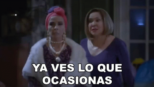 Two Women Are Standing Next To Each Other With The Words Ya Ves Lo Que Ocasionas Written On The Screen GIF